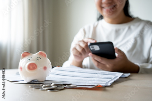 Woman checking money save interest and profit on mobile phone. Online banking transaction concept.
