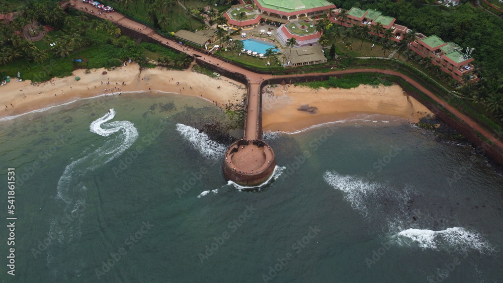 Goa, India 19th October 2022: Drone shots Fort Aguada in North Goa - Seventeenth-century Portuguese fort standing on Sinquerim Beach. Popular also Watersports activities and white sand beach.  