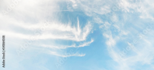 Beautiful clear light blue sky with white clouds in sunny day. Wallpaper background.