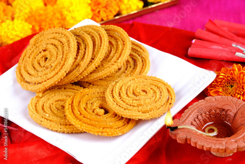 Indian Traditional Snack Chakli, a spiral shaped, Chakali or murukku Indian Traditional Tea Time Snack, Traditional Diwali festival snacks in India. photo