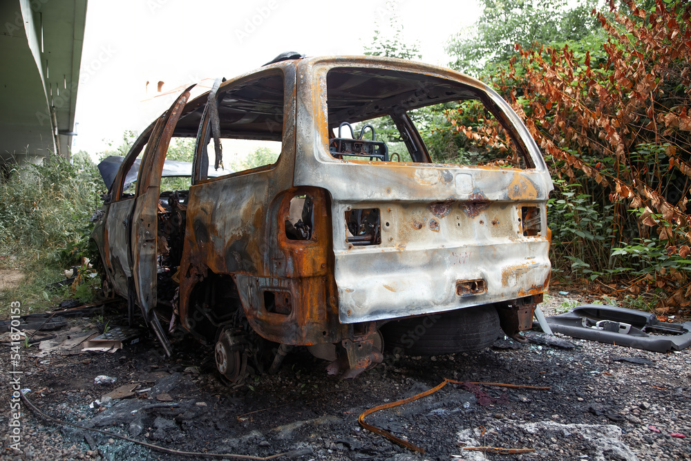 Car after a fire. Burnt rusty car after fire or accident. Car after the fire, crime of vandalism, riots. Arson car. Accident on the road due to speeding. Explosion. Car after a fire. Burnt rusty car after fire or accident. Car after the fire, crime of vandalism, riots. Arson car. Accident on the road due to speeding. Explosion.