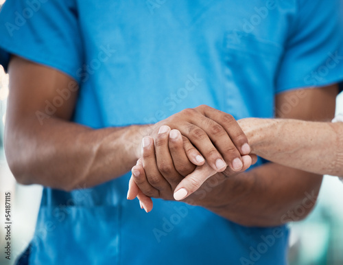 Hands, support and nurse helping patient in hospital, care and empathy for people. Healthcare, assistance and black man or doctor holding hands of senior person for comfort after cancer diagnosis.