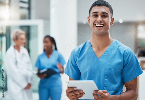 Tablet, healthcare and medicine with a man nurse doing research in a hospital for health or treatment. Medical, insurance and medicare with a young male clinic worker doing a search online photo