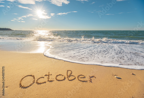 October word on sea sand.