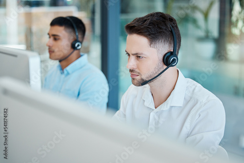 Call center, focused businessman and helping with customer service advice online. Operator, telemarketing and consultant offering digital support using a headset. Hotline agent, contact us and help