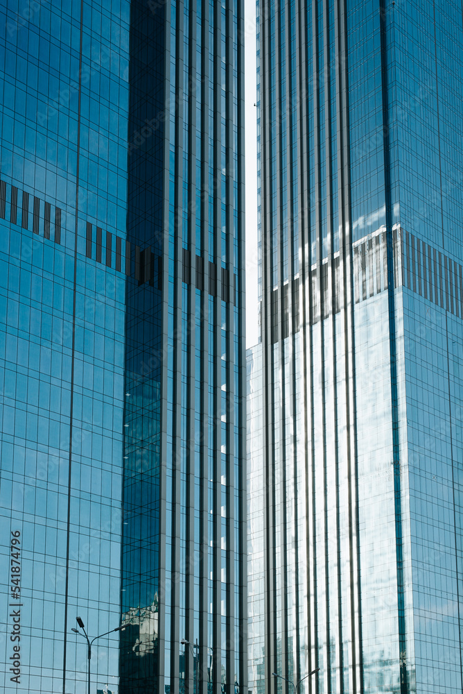 Skyscrapers with blue glass windows, exterior. Modern tall buildings, trendy architecture