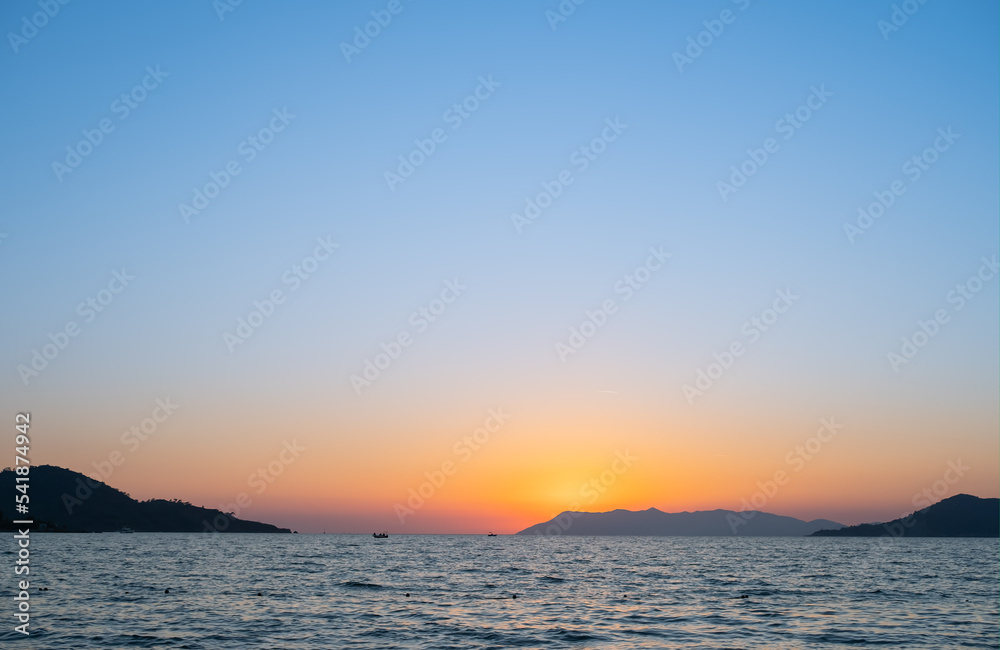 Sunset over the sea and islands, mediterranean sea, background or wallpaper idea for vacation advertising