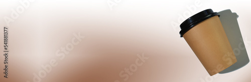 Cardboard coffee cup with a plastic lid on a white-beige background. Banner with copy space. The concept of ecology, recycling, environmental protection