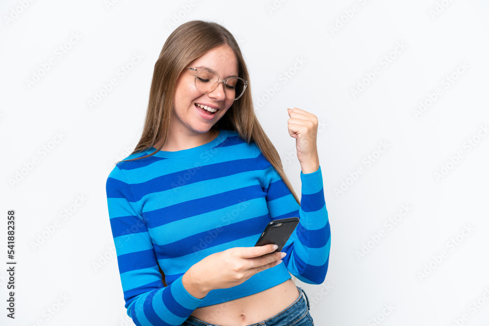 Young beautiful blonde woman isolated on white background with phone in victory position Young beautiful blonde woman isolated on white background with phone in victory position