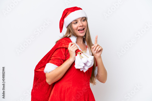 Young caucasian woman dressed as mama noel holding Christmas sack isolated on white background intending to realizes the solution while lifting a finger up