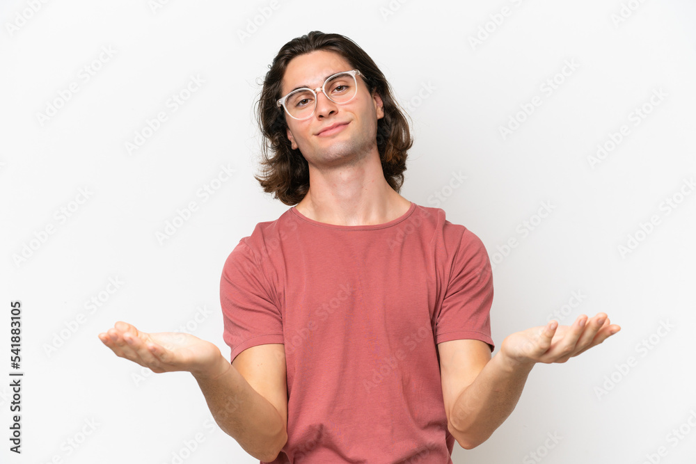 Young handsome man isolated on white background having doubts Young handsome man isolated on white background having doubts