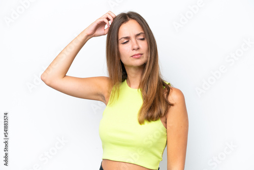 Young caucasian woman isolated on white background having doubts while scratching head