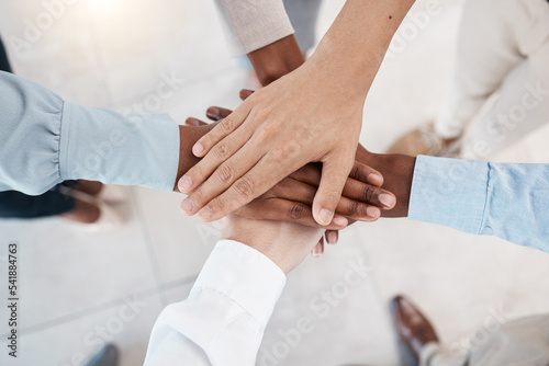 Hands, teamwork and motivation with business people standing in a huddle or circle together from above. Office, meeting and solidarity with a man and woman employee group joined in unity or trust