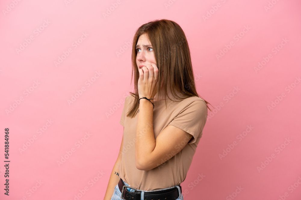 Young English woman isolated on pink background is a little bit nervous Young English woman isolated on pink background is a little bit nervous