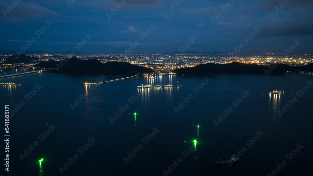 aerial view seascape twilight and lighting from refinery and oil ship in sea blue sky background