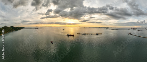 panorama seascape and the sunset small oil ship sailing in sea aerial view