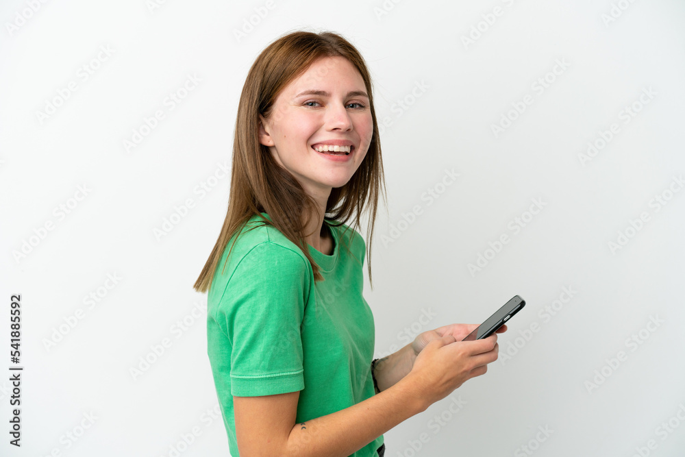 Young English woman isolated on white background sending a message or email with the mobile Young English woman isolated on white background sending a message or email with the mobile