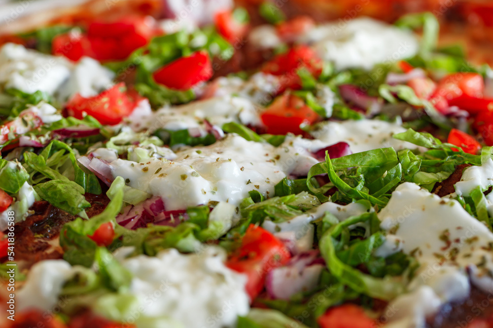 Turkish pizza with lamb tomatoes lettuce onion and yogurt