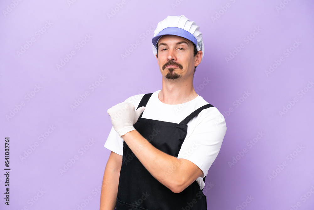 Fishmonger man wearing an apron isolated on purple background proud and self-satisfied Fishmonger man wearing an apron isolated on purple background proud and self-satisfied
