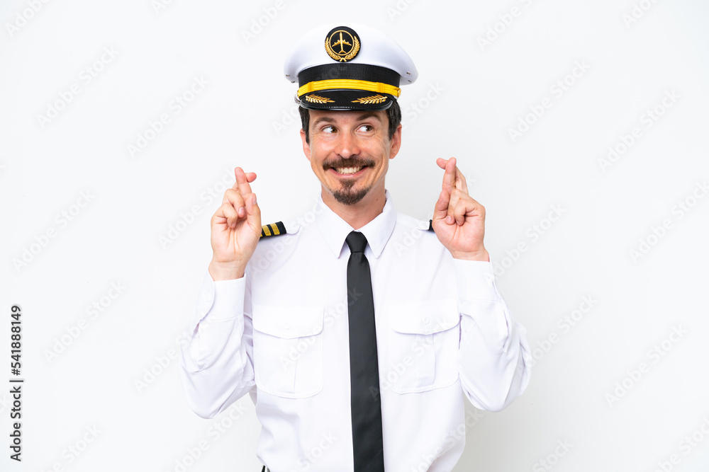 Airplane caucasian pilot isolated on white background with fingers crossing Airplane caucasian pilot isolated on white background with fingers crossing