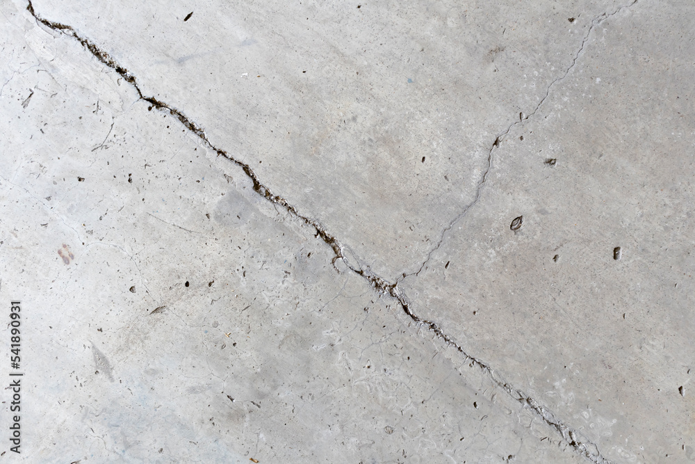 Obraz premium Background of a beautiful concrete wall with oblique wall fractures