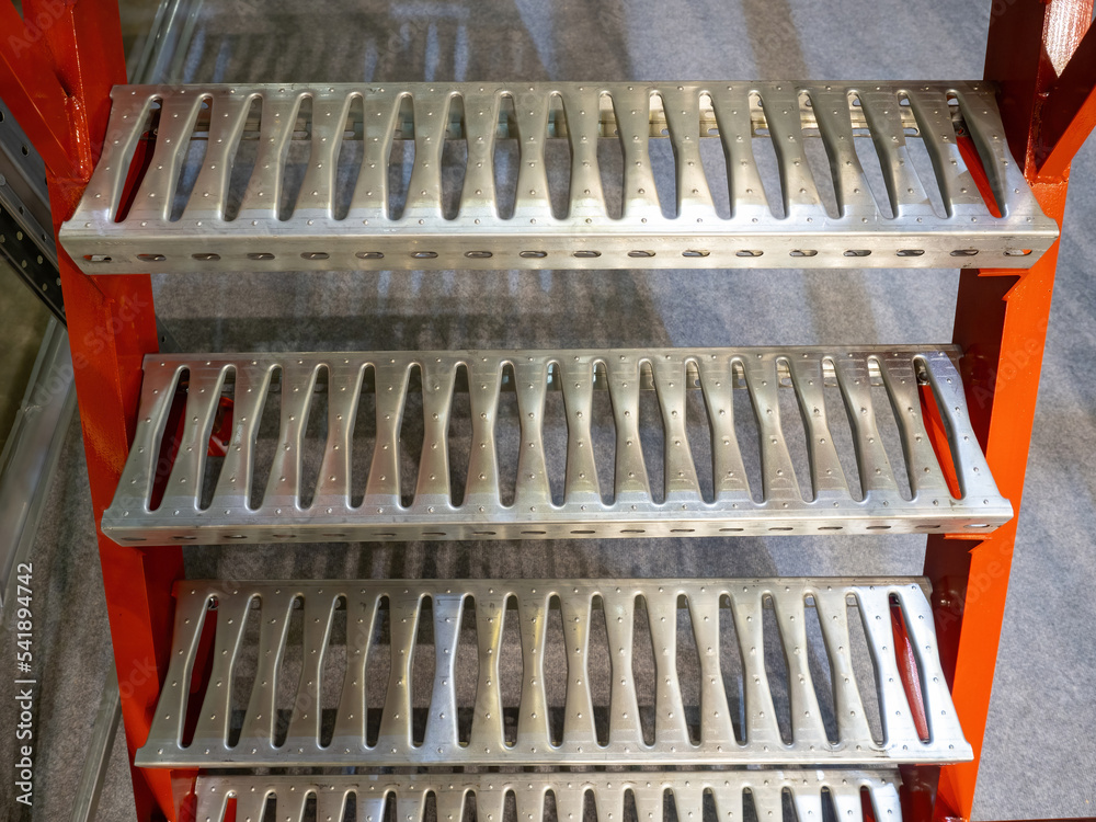 Steel steps. Fragment mezzanine. Steps to climb to mezzanine. Production equipment. Steps for climbing temporary structure. Warehouse and industrial furniture. Iron stairs. Fragment of stepladder Steel steps. Fragment mezzanine. Steps to climb to mezzanine. Production equipment. Steps for climbing temporary structure. Warehouse and industrial furniture. Iron stairs. Fragment of stepladder