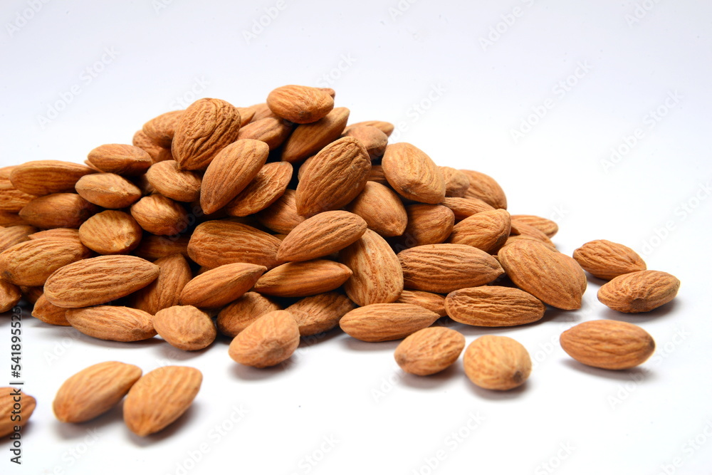 Fresh almonds in the wooden bowl, Organic almonds, almonds border white background, Almond nuts on a dark wooden background. Healthy snacks. Top view. Free space for text. Fresh almonds in the wooden bowl, Organic almonds, almonds border white background, Almond nuts on a dark wooden background. Healthy snacks. Top view. Free space for text.