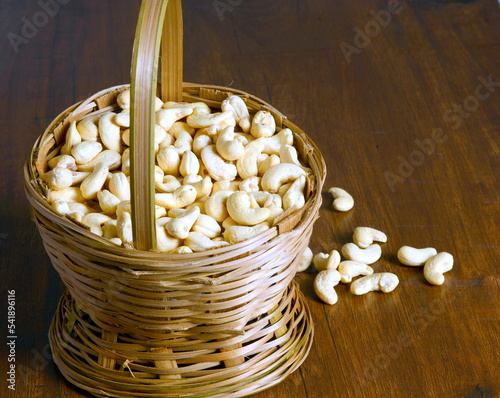 Fresh almonds in the wooden bowl, Organic almonds, almonds border white background, Almond nuts on a dark wooden background. Healthy snacks. Top view. Free space for text.