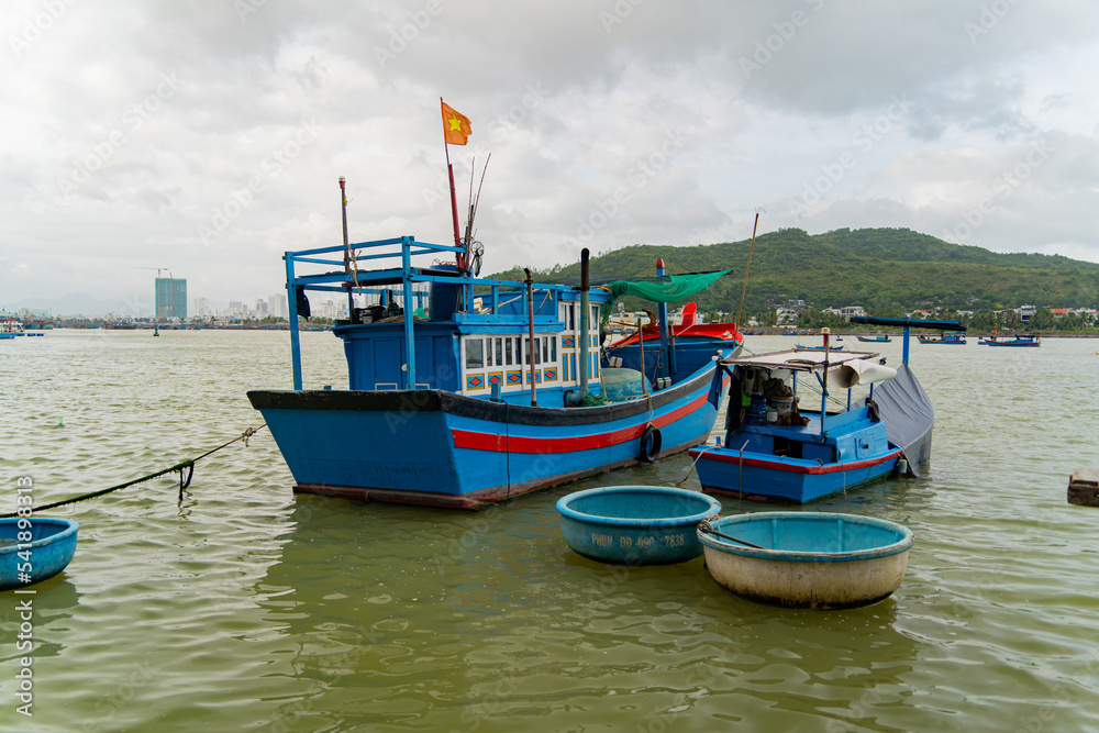 Seaport of fishing vessels in Vietnam. The southern part of Nha Trang city on a cloudy day. 