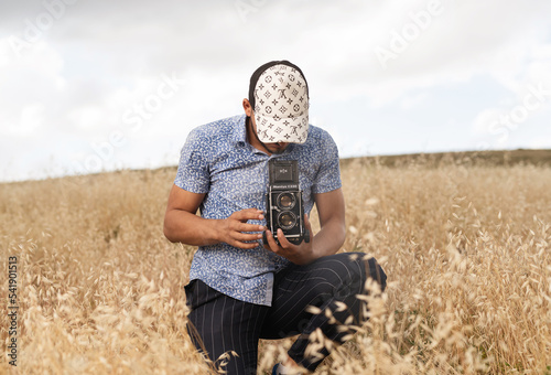 photographer holding old film camera mamiya c330 photo