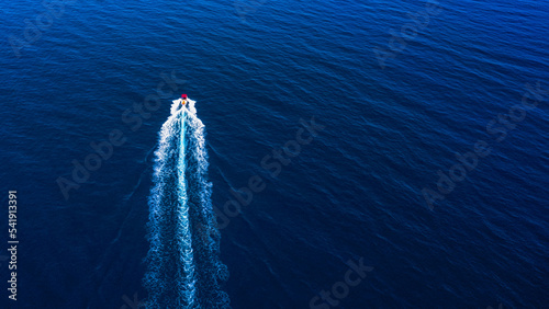 Aerial view of small boat flowing in Mediterranean sea, travel and vacation concept