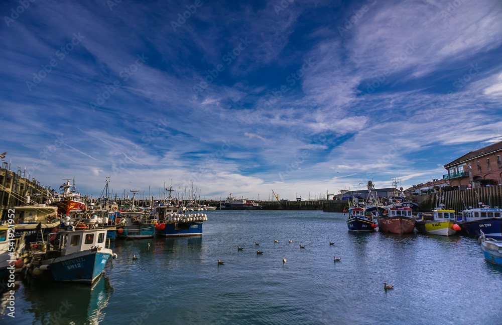Boats moored in Scarborough Harbour on a sunny autumn day.