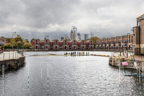 Watersports in Shadwell Dock in East London and looming skyscrapers photo