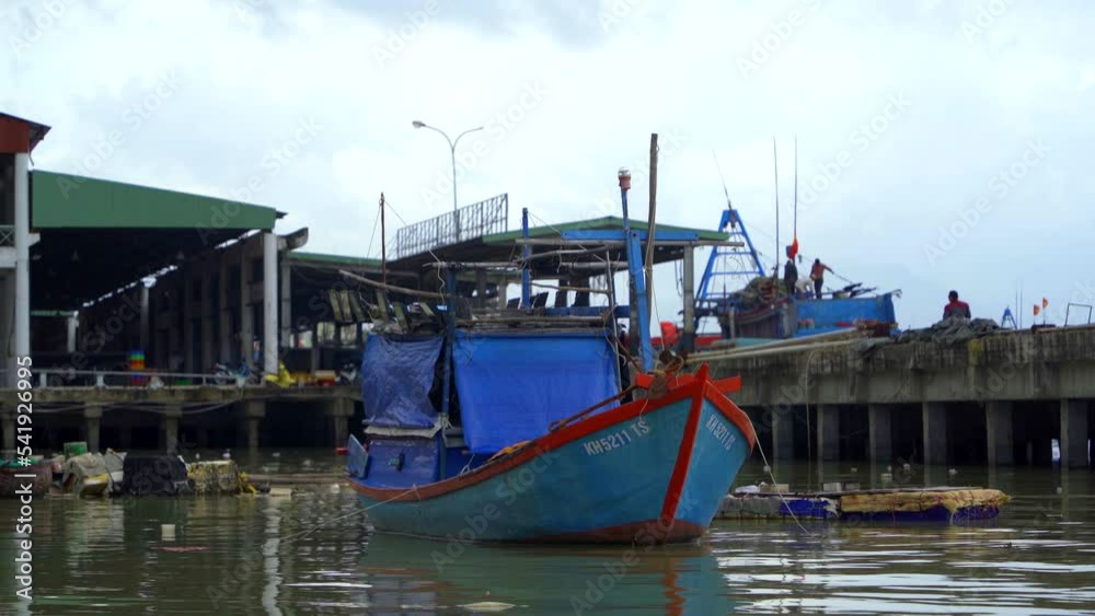 Seaport of fishing vessels in Vietnam. The southern part of Nha Trang city on a cloudy day.