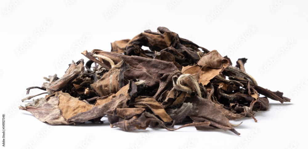Tea leaves. Pile of old dry white tea leaves on a white background. Tea leaves. Pile of old dry white tea leaves on a white background.