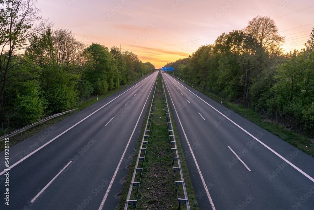 empty highway road in the sunset