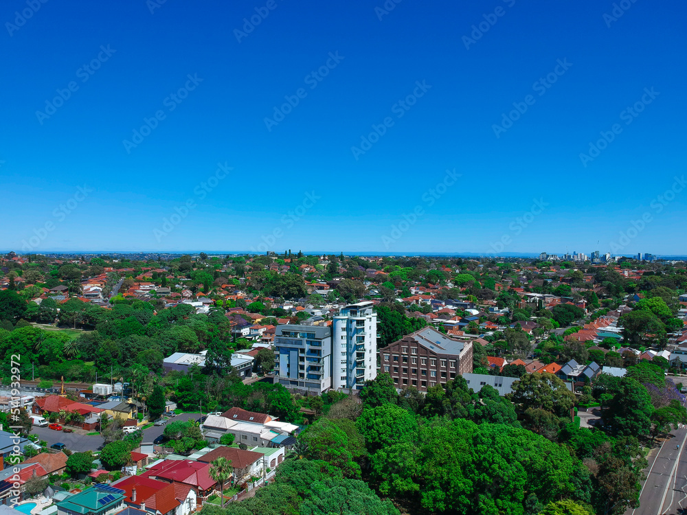 Panoramic Aerial Drone view of Suburban Sydney housing, roof tops, the streets and the parks