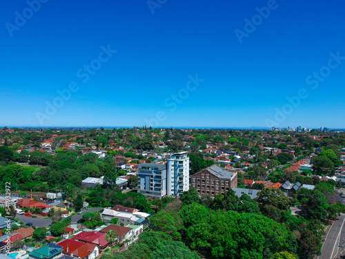 Panoramic Aerial Drone view of Suburban Sydney housing  roof tops  the streets and the parks