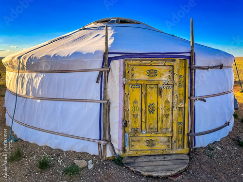 White Mongolian ger with a yellow door photo