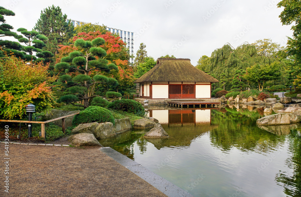 Amazing view on Japanese garden in Hamburg with pond and teahouse and reflctions in water Amazing view on Japanese garden in Hamburg with pond and teahouse and reflctions in water