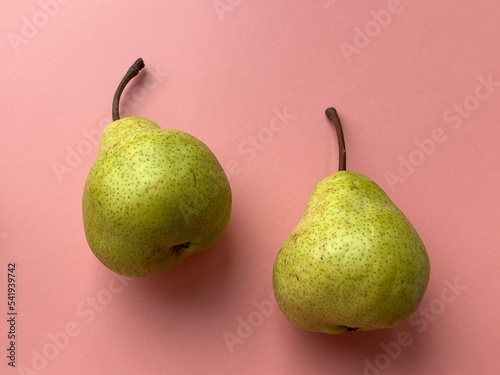 Two pears on a pink background