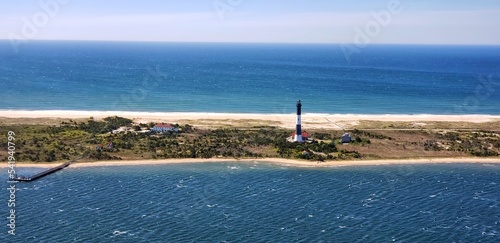 The Fire Island Lighthouse is a visible landmark on the Great South Bay, in southern Suffolk County, New York on the western end of Fire Island, a barrier island off the coast of Long Island photo