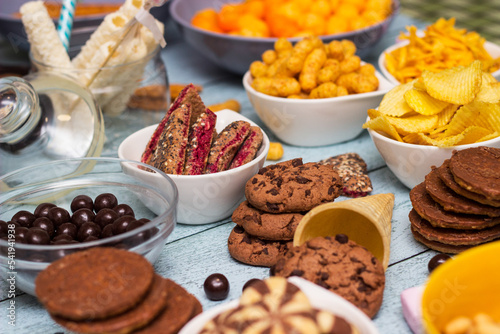 Salty and sweet snacks. Table of salty and sweet snacks. Large group of unhealthy food