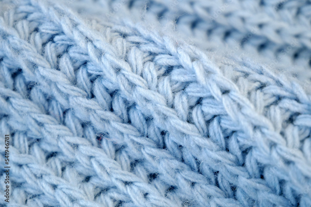 Details of knitted woolen fabric. blue textile background. Woolen Texture Background, Knitted Wool Fabric, Hairy Fluffy Textile Details of knitted woolen fabric. blue textile background. Woolen Texture Background, Knitted Wool Fabric, Hairy Fluffy Textile