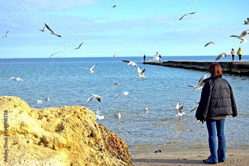 Feeding seagulls by the sea