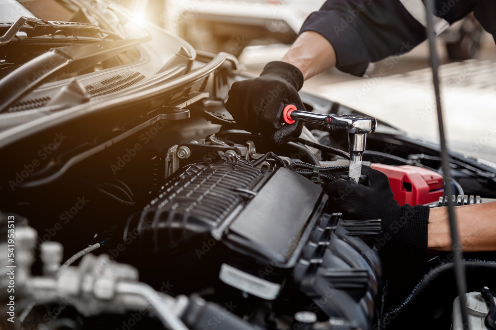 Car care maintenance and servicing, Close-up hand technician auto mechanic using the wrench to repairing change spare part car engine problem and insurance service support. Car care maintenance and servicing, Close-up hand technician auto mechanic using the wrench to repairing change spare part car engine problem and insurance service support.