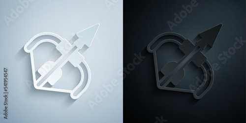 Paper cut Medieval bow and arrow icon isolated on grey and black background. Medieval weapon. Paper art style. Vector