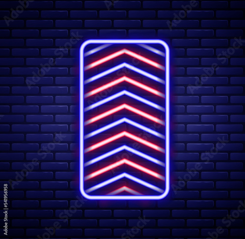 Glowing neon line Car tire wheel icon isolated on brick wall background. Colorful outline concept. Vector