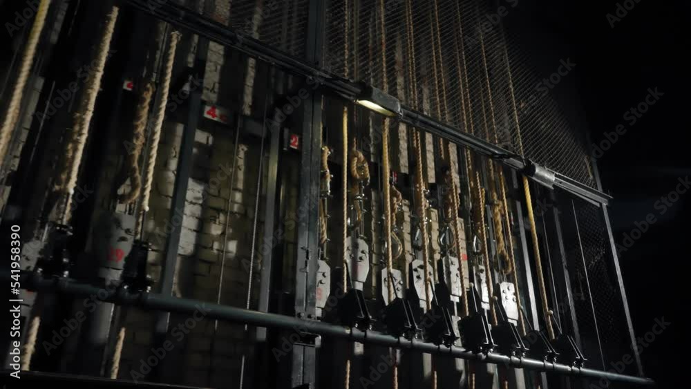 Manual system of lifting and lowering devices behind the scenes of the theater stage. The mechanics of the scene behind the curtain. Shtankety. Concert hall equipment Manual system of lifting and lowering devices behind the scenes of the theater stage. The mechanics of the scene behind the curtain. Shtankety. Concert hall equipment