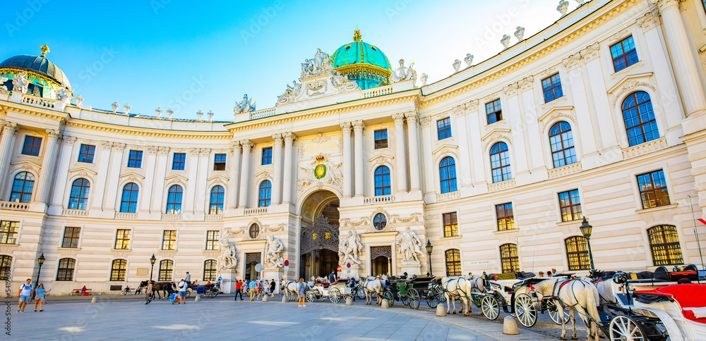 Hofburg Palace and horse carriages parking in Vienna inner city, Austria